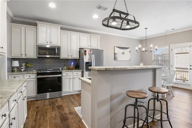 Kitchen with stainless steel appliances, a center 