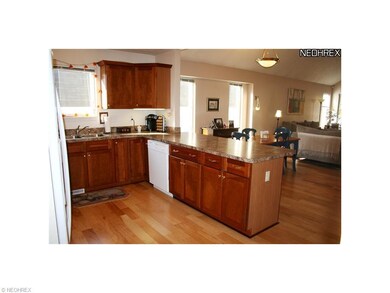 Kitchen with all appliances and hardwood floor.
