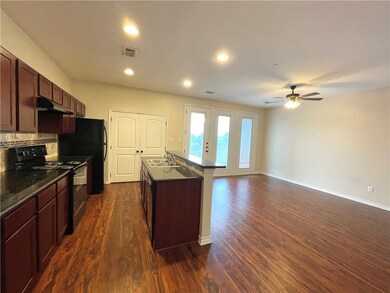 Kitchen featuring dark countertops, electric range