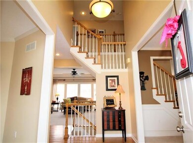 Entry hall features hardwood floors and grand stai