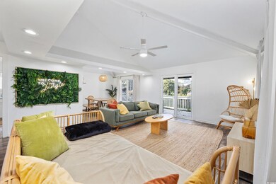 Living room featuring ceiling fan, lofted ceiling 