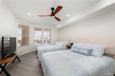 Bedroom featuring wood finish floors, baseboards, recessed lighting, and ceiling fan