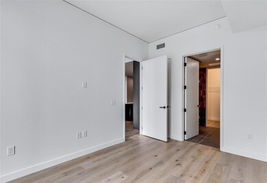 Unfurnished bedroom featuring light wood-type flooring and baseboards