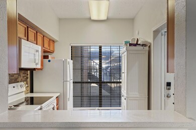 Kitchen featuring light stone countertops and whit