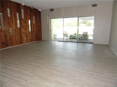 View of living area from front door entry. Pecky c