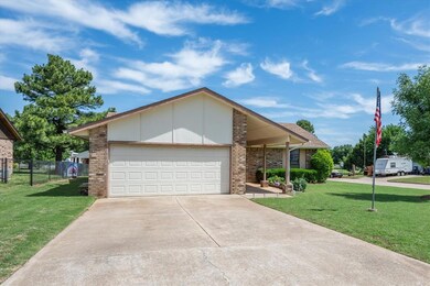 Single story home featuring a garage and a front y