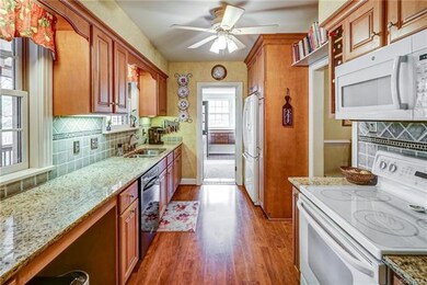 Kitchen is updated with granite counter tops, under cabinet lighting and pull out shelves in cabinets.