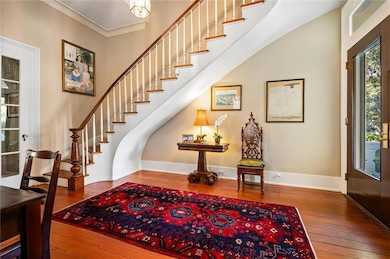 Open Foyer with the curved staircase leading to the upstairs.