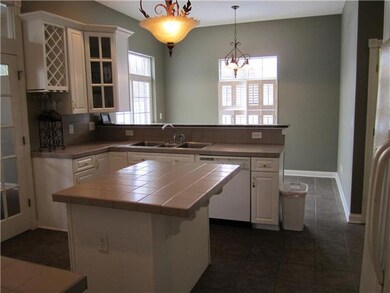 Kitchen. Adjoining breakfast area with wrap-around patio & yard access is perfect for a pub-style table or use stools at the granite breakfast bar.