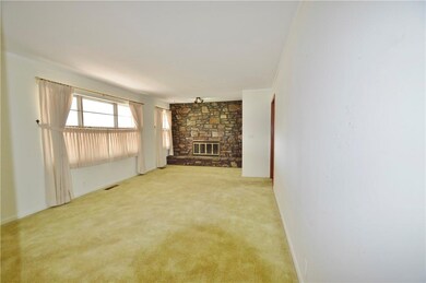 Living room with wood-burning fireplace.