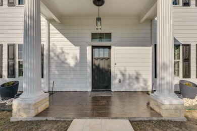 Property entrance with covered porch