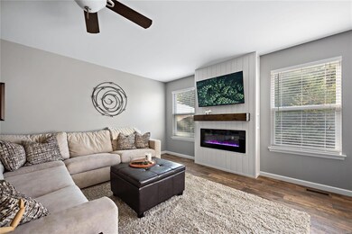 Great room with electric fireplace and view to woo