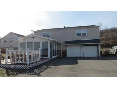 Exterior Back. The deck and 3 season room are rece