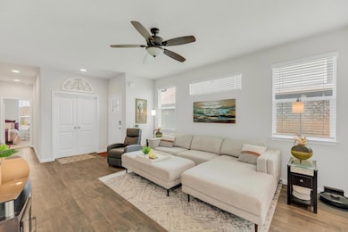 Living area featuring wood finished floors, a cei