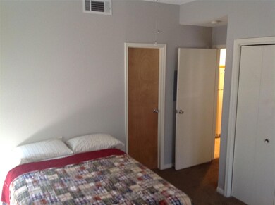 Bedroom featuring visible vents, a closet, and ca