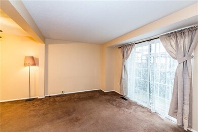 Living room has neutral decor and provides access 