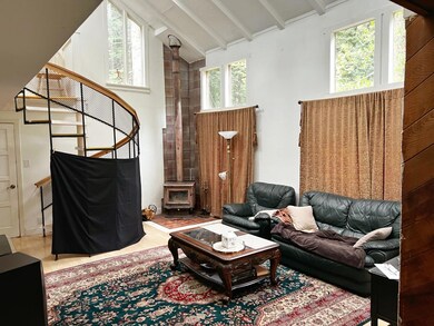 Living room of main house with cozy wood burning s
