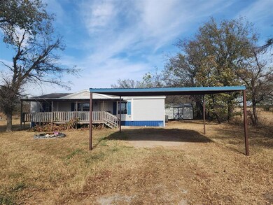 View of front of home with a front yard, a shed, a