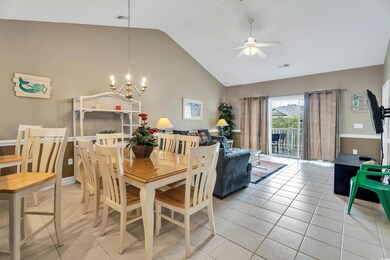 Tiled dining space featuring ceiling fan with nota
