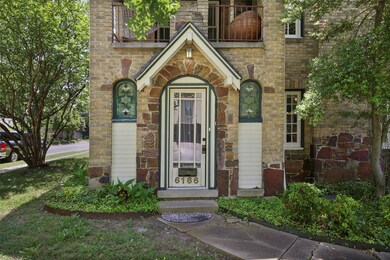 Entrance to property featuring brick siding and stone siding