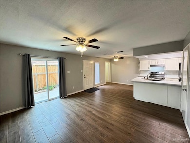 Living room featuring a New Sliding Door to the Outdoor Patio & Featuring Ceiling Fans w/LED Lighting, Wood-type Flooring, and a new Kitchen Sink!