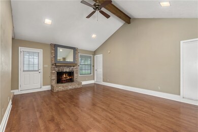 Unfurnished living room featuring ceiling fan, a b