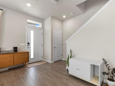 Foyer entrance featuring wood finished floors and