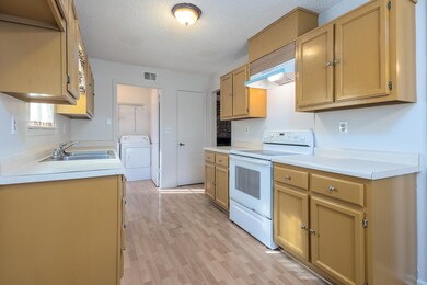 Kitchen featuring white electric range oven, visib