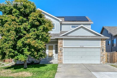 View of front of house featuring driveway, stone siding, roof with shingles, and an attached garage