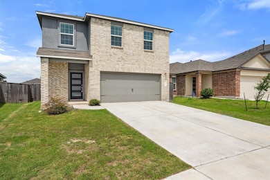 Traditional-style home with a garage, brick sidin
