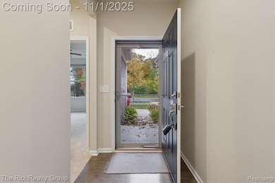 Entryway with dark wood-style floors and baseboards