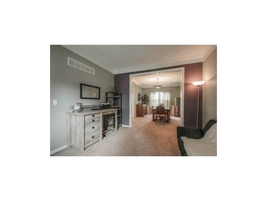 VIEW OF OFFICE LEADING INTO FORMAL DINING ROOM.