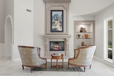 Living room with custom fireplace and built in she