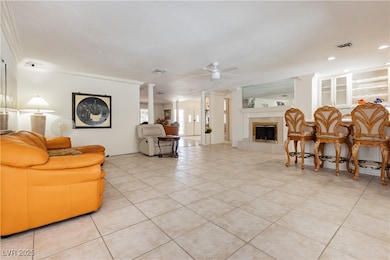 Living area with ceiling fan, light tile patterned
