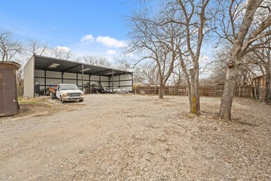 View of car parking with a carport, fence, and dir