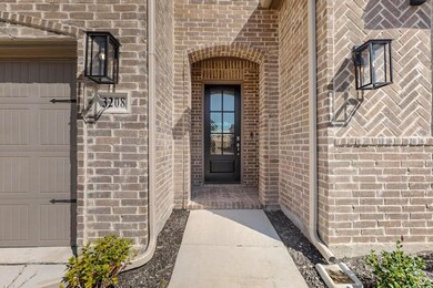 View of exterior entry with brick siding