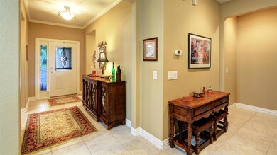 Entrance foyer featuring crown molding and light t