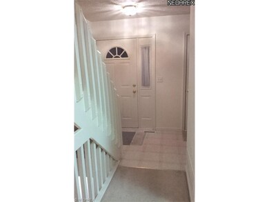 Spacious foyer with neutral colors.  To the right 