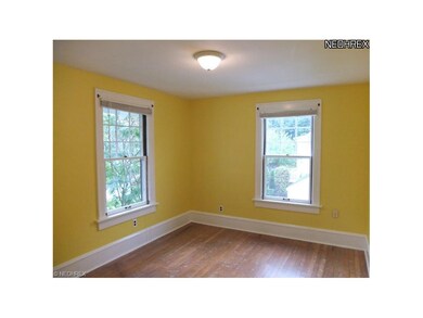 Bedroom 2 with hardwood floors.