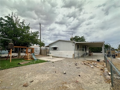 View of side of home with a patio area, a gate, and a playground