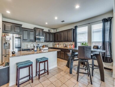 Kitchen with stainless steel appliances, backsplas