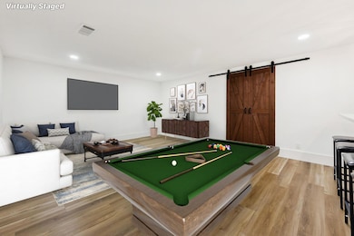 Playroom with visible vents, a barn door, recesse