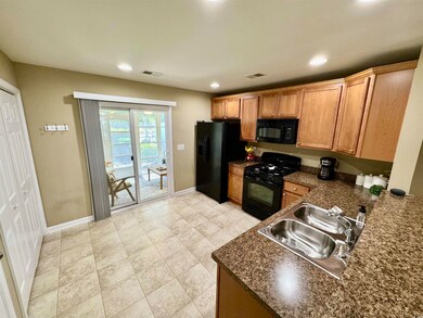 Kitchen featuring black appliances, sink, dark sto