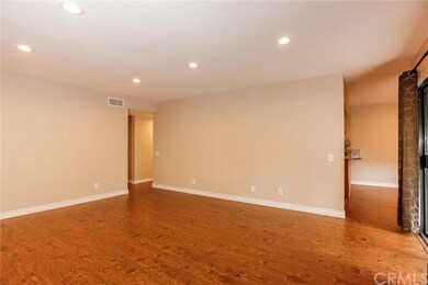 Large living room with scraped ceilings, wood lami