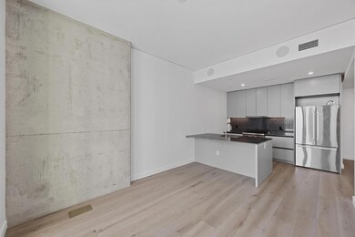 Kitchen with freestanding refrigerator, a peninsu