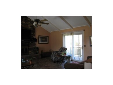 Great room slider to Deck, tile floors and vaulted