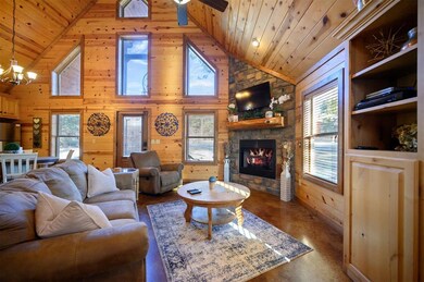 Living room with wood ceiling, wooden walls, and h