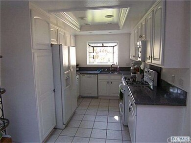 Newer remodeled kitchen with white cabinets, pull-