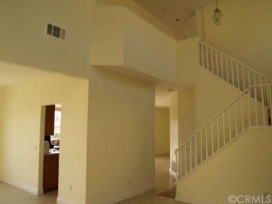 Large spacious living room with vaulted ceilings.  Fresh paint and new tile flooring and baseboards. 