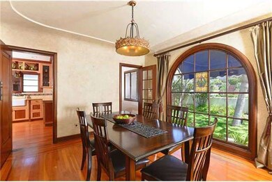 Dining room with arched windows and what are belie